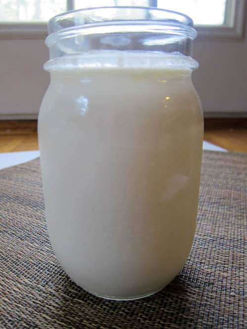 a small jar of separated liquid cream