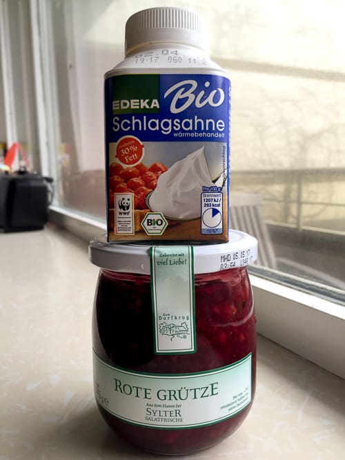 A jar of Rote Grütze or red berry pudding and a pack of schlagsahne or whipped cream