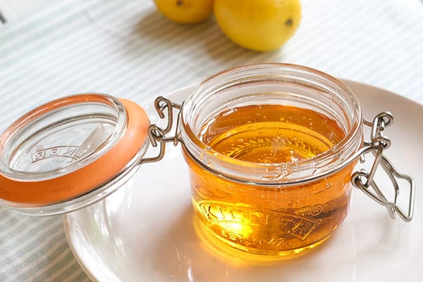 golden syrup inside a small glass jar with an open lid