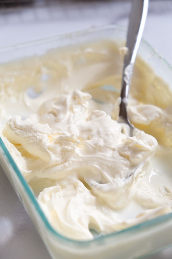 thick, creamy, white, and smooth clotted cream on baking dish