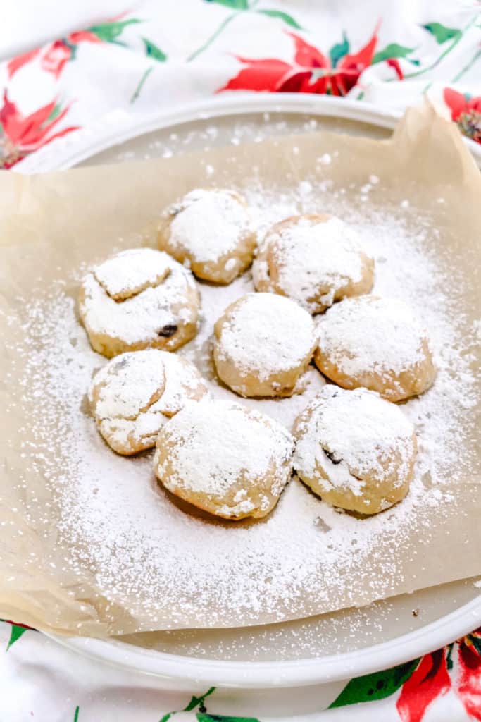 a plate of baked Stollen bites brushed with butter and sprinkled with powdered sugar