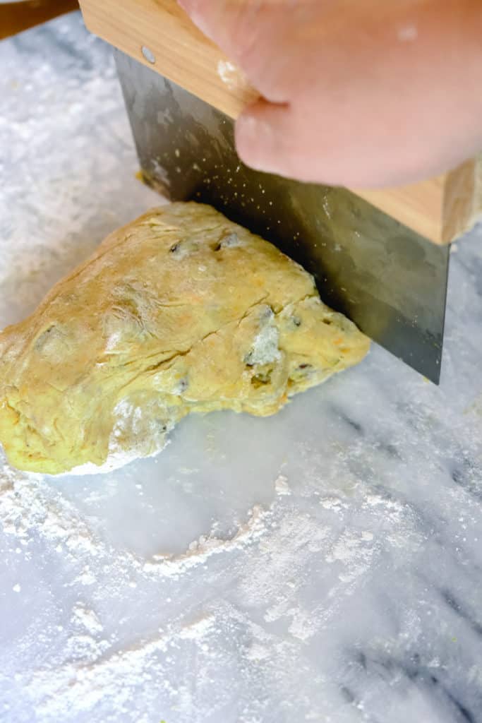 Dividing the dough into two parts using a pastry scraper