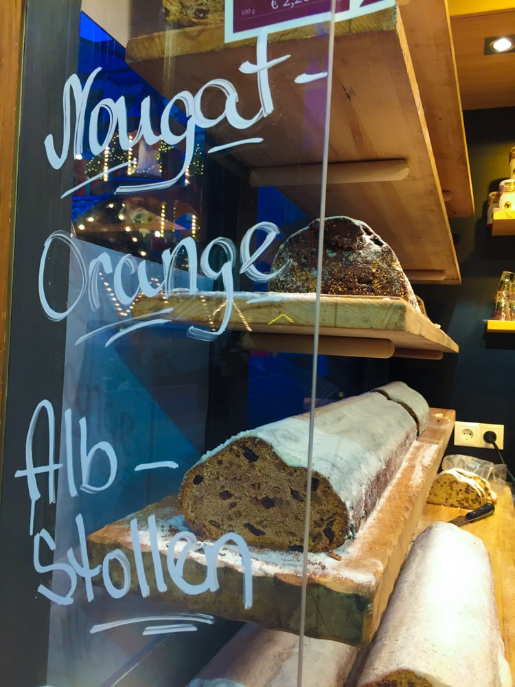 stand at a Christmas market with different kinds of Stollen