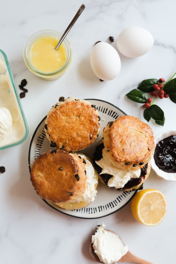 British Currant Scones with cream and jam on plate