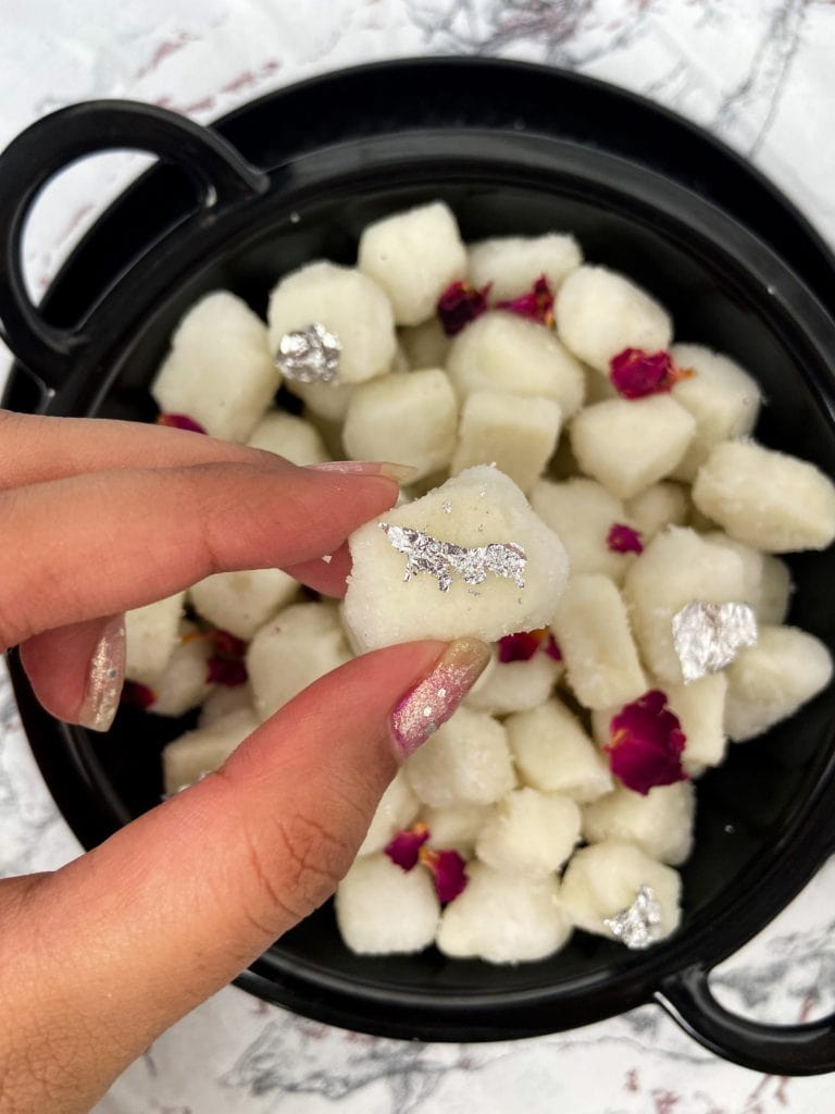 Bowl of Chena Murki made from paneer cheese coated with sugar.