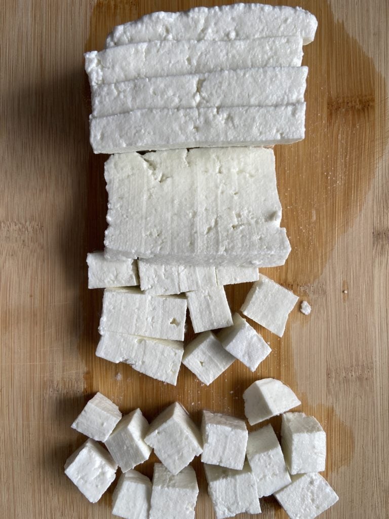 Paneer cut into small squares of equal sizes.
