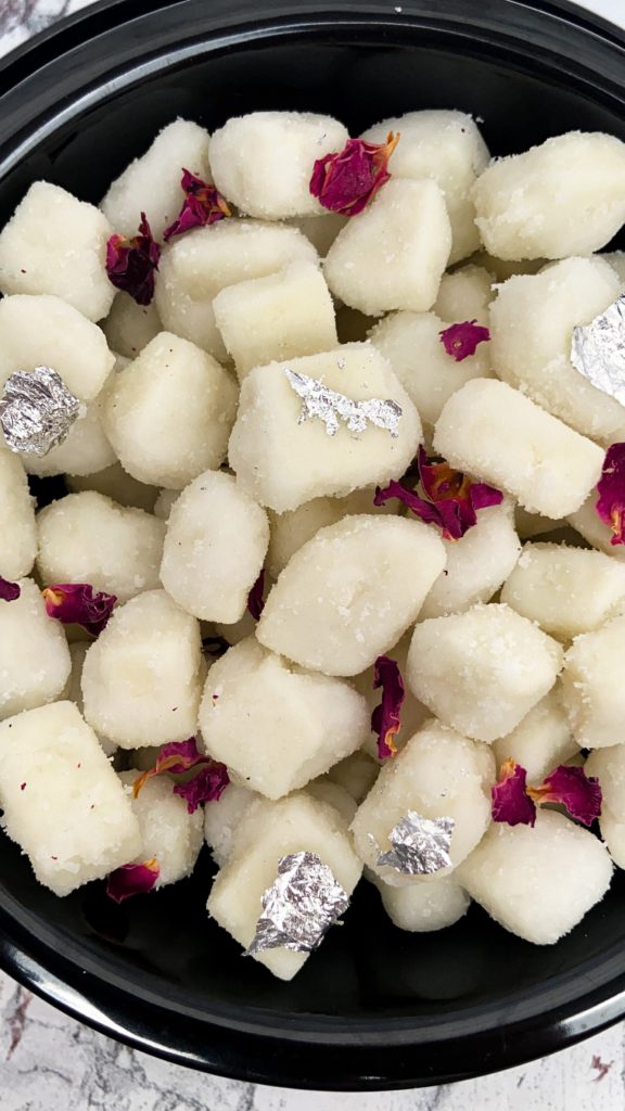 plate of small diced paneer cheese cooked in sugar syrup and flavored with cardamom powder, rose water or saffron strands