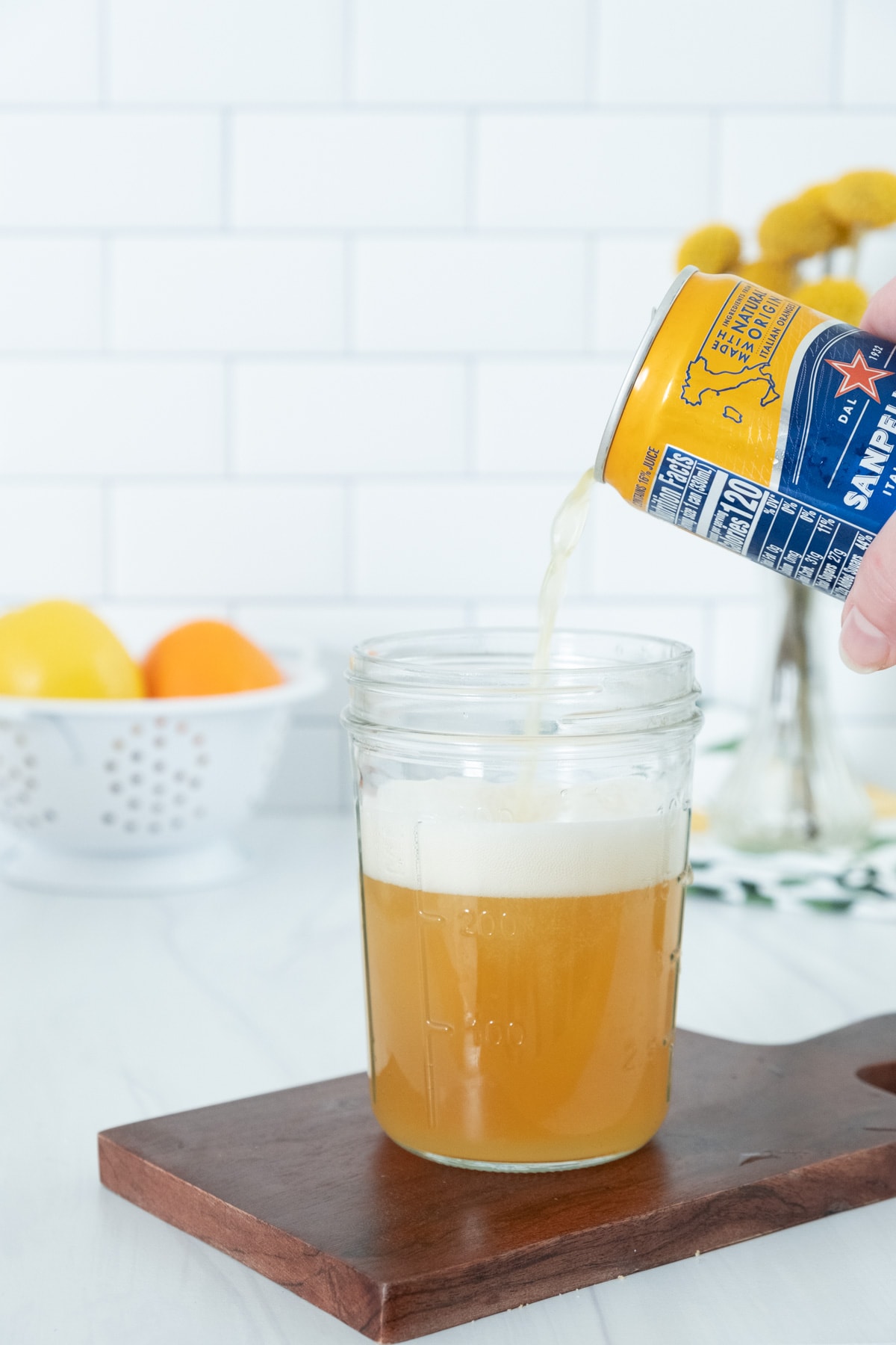 pour orange soda into a glass