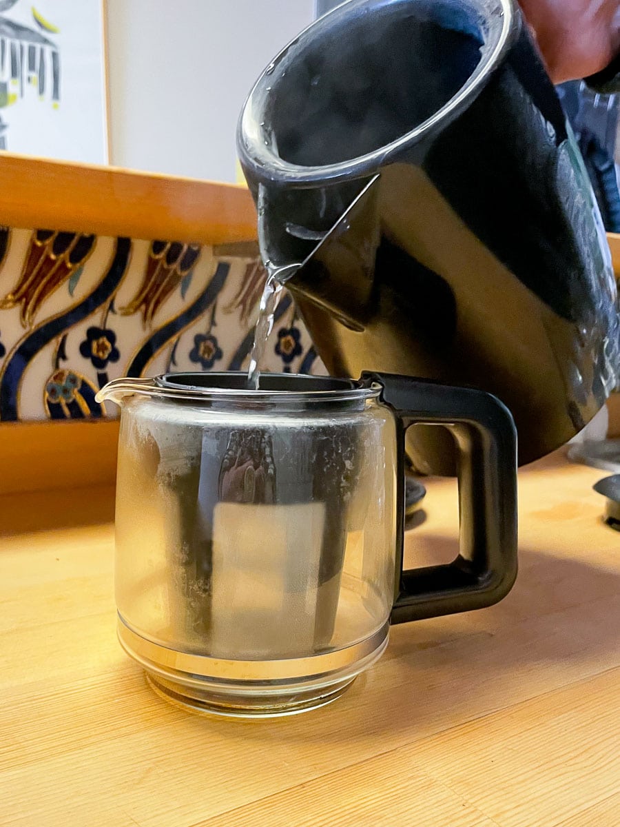 pour boiled water in to tea pot 