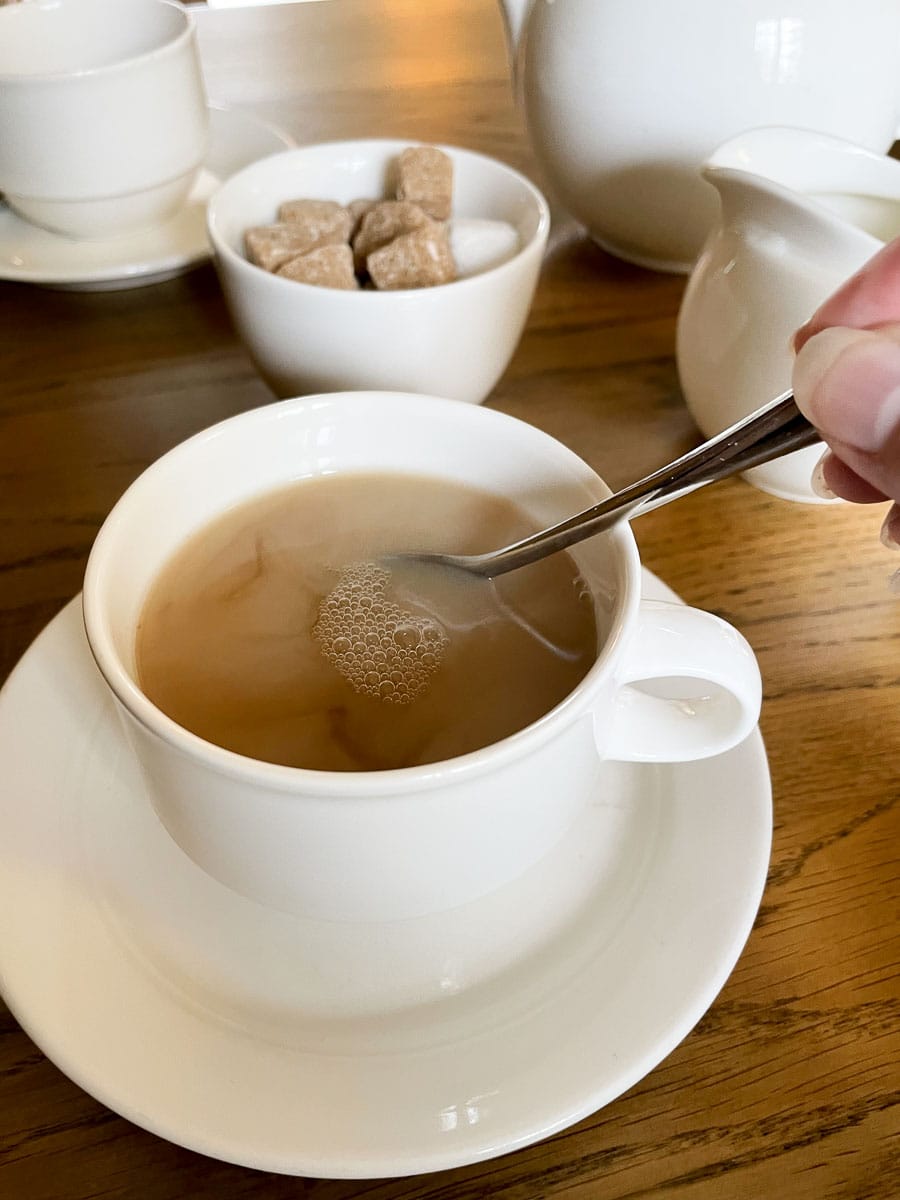 stirring cream into tea